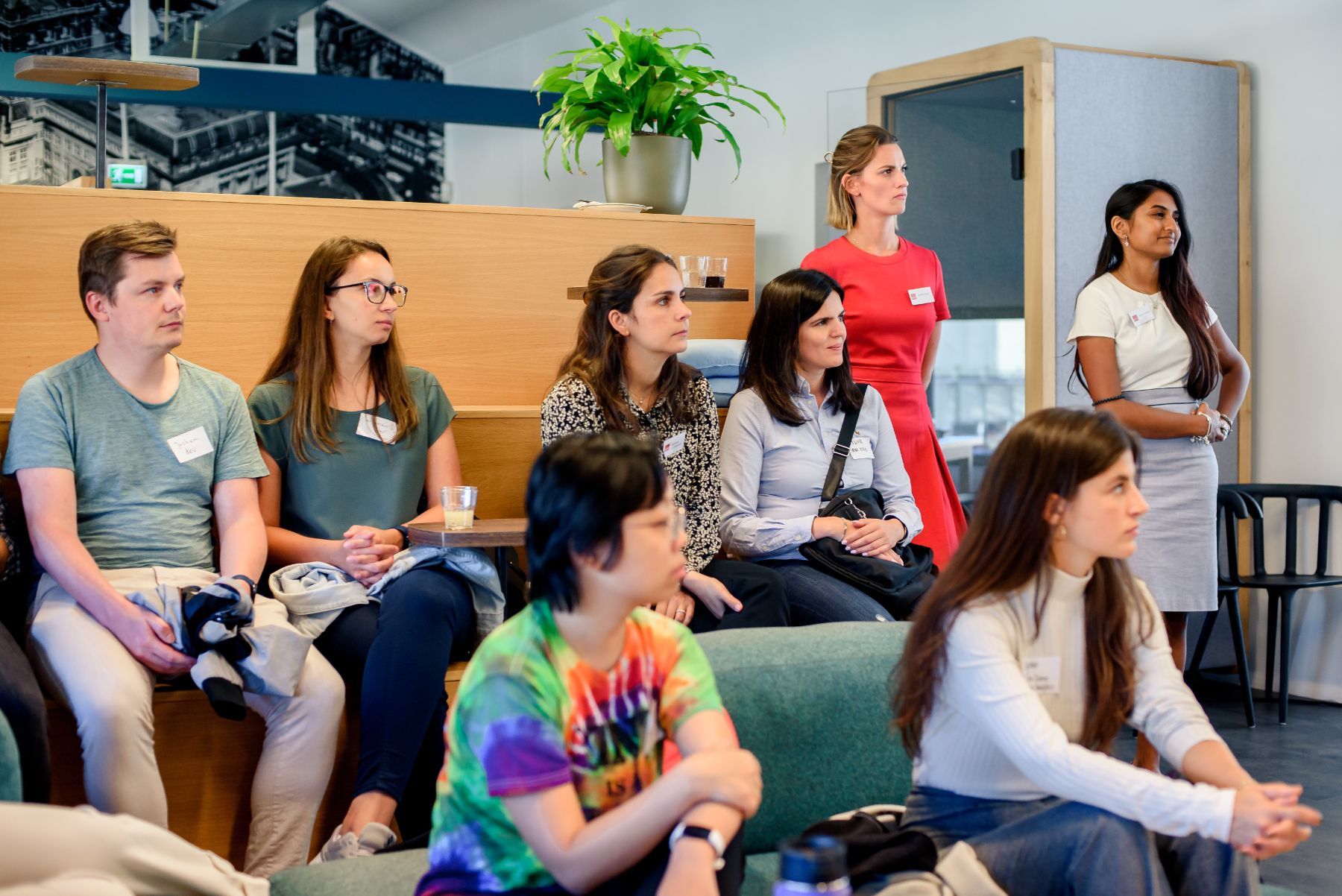 Attendees listening to a hiring team presentation at an OutGeek Women in Tech recruiting event